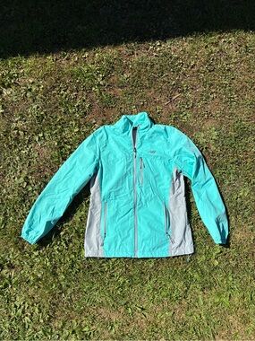 Woman’s New Balance teal blue wind breaker light jacket
